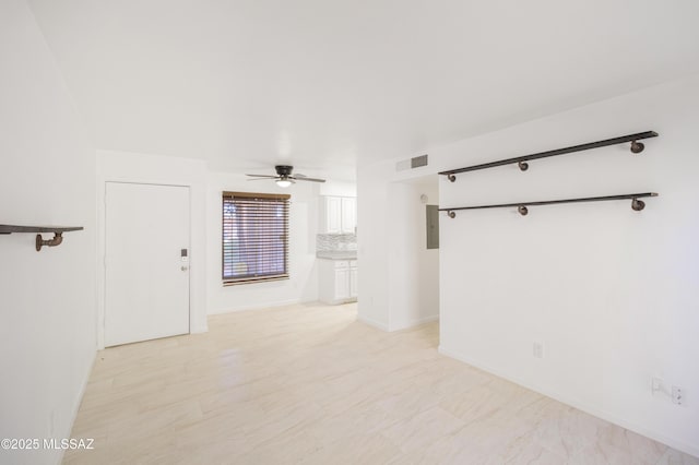 empty room featuring electric panel and ceiling fan