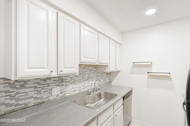 kitchen featuring sink, backsplash, stainless steel dishwasher, and white cabinets