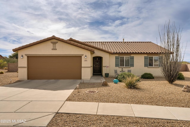 view of front of property featuring a garage, driveway, a tiled roof, and stucco siding