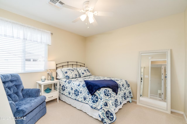 carpeted bedroom featuring ceiling fan, visible vents, and baseboards