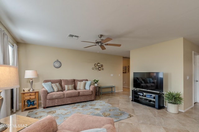 living room featuring ceiling fan, visible vents, and baseboards