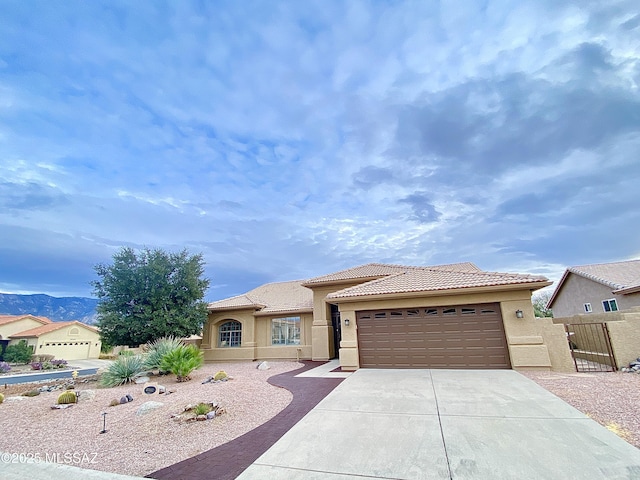 view of front of house with a mountain view and a garage