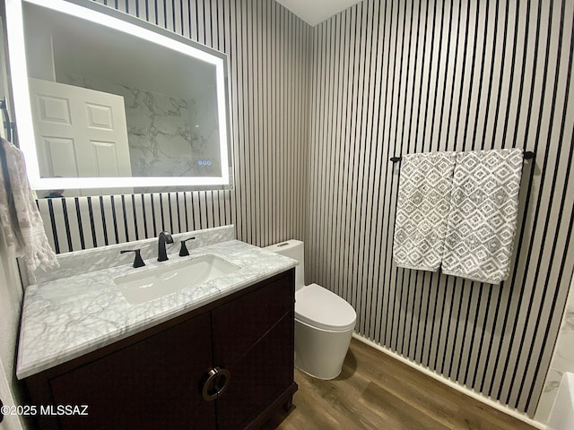 bathroom featuring hardwood / wood-style flooring, vanity, and toilet