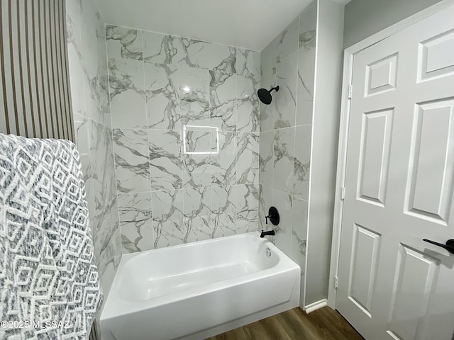 bathroom featuring hardwood / wood-style flooring and tiled shower / bath