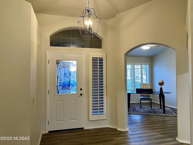 foyer entrance featuring dark hardwood / wood-style flooring and a chandelier