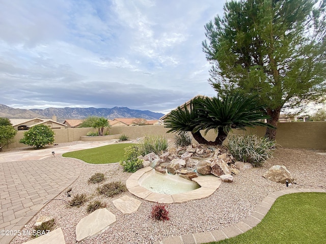 view of yard featuring a mountain view and a patio area