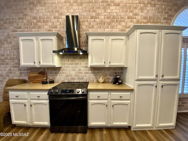 kitchen with range with electric cooktop, wall chimney exhaust hood, and dark hardwood / wood-style floors