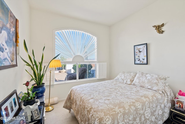 bedroom featuring carpet and baseboards