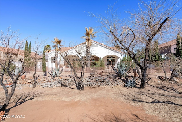 view of front of house featuring a fenced front yard and stucco siding