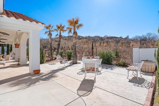 view of patio / terrace featuring ceiling fan, fence, and outdoor dining space
