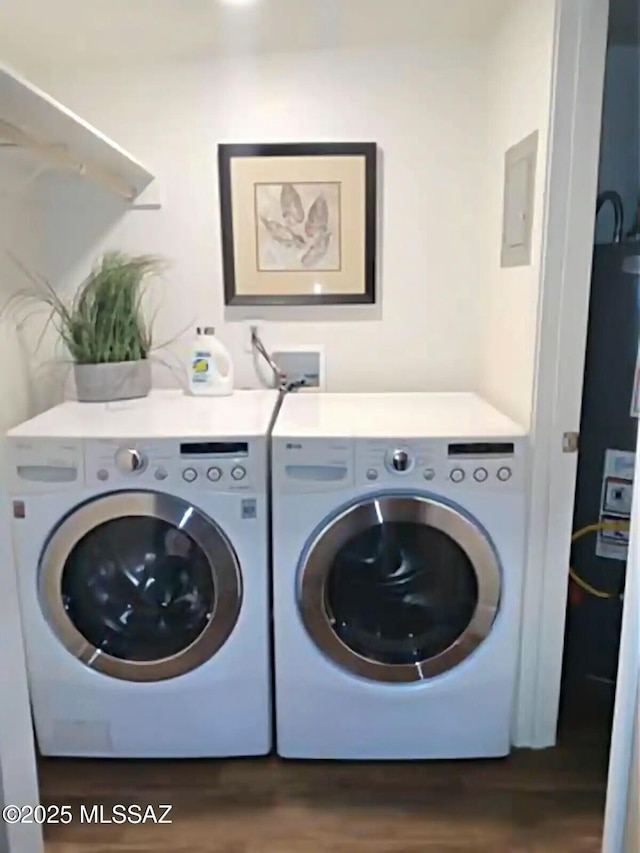 laundry area featuring dark hardwood / wood-style floors and washer and dryer