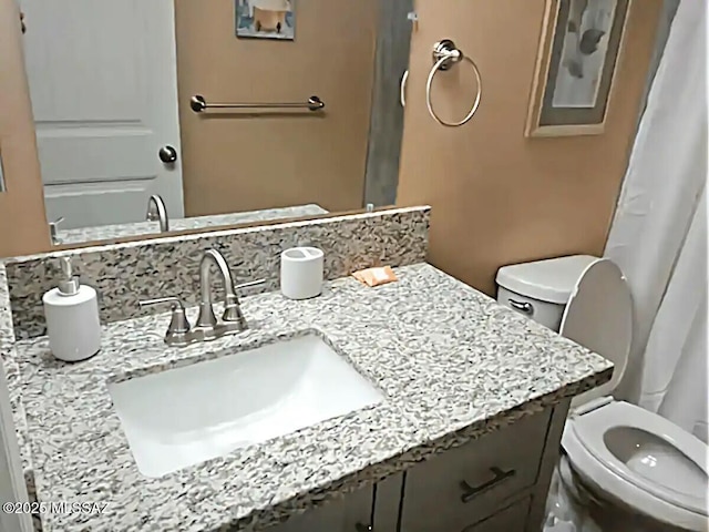 bathroom with vanity and toilet