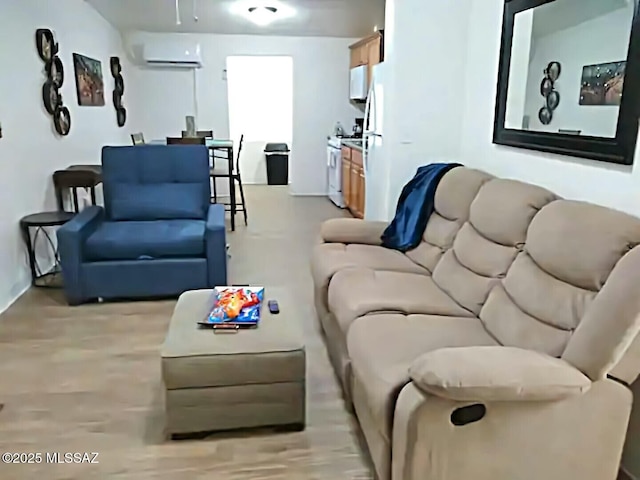 living room with light hardwood / wood-style floors and a wall mounted AC