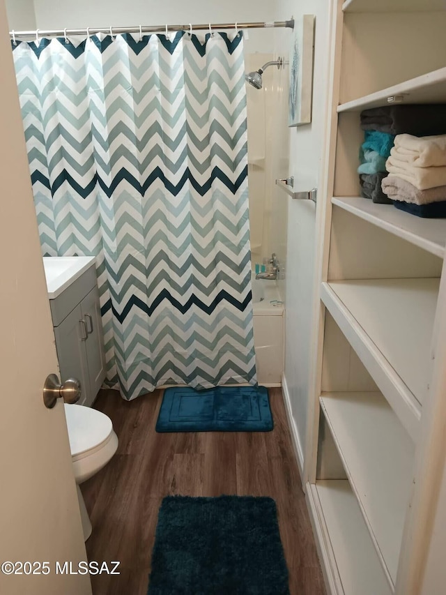 full bathroom with shower / bath combination with curtain, vanity, toilet, and hardwood / wood-style floors