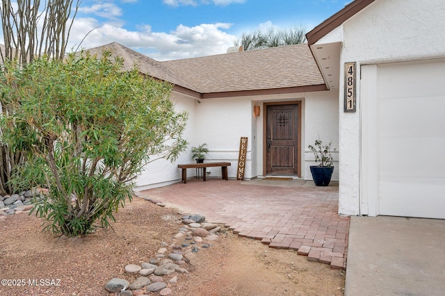 view of exterior entry featuring a patio