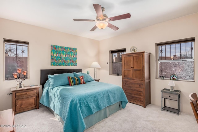 bedroom featuring ceiling fan and light carpet