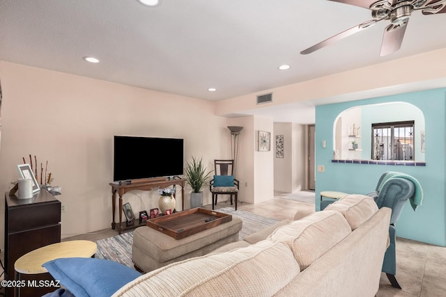 tiled living room featuring ceiling fan