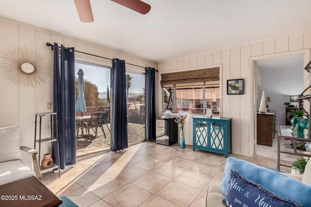 tiled living room with ceiling fan