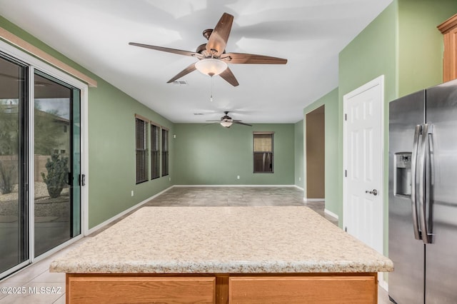 kitchen with stainless steel refrigerator with ice dispenser and light tile patterned flooring