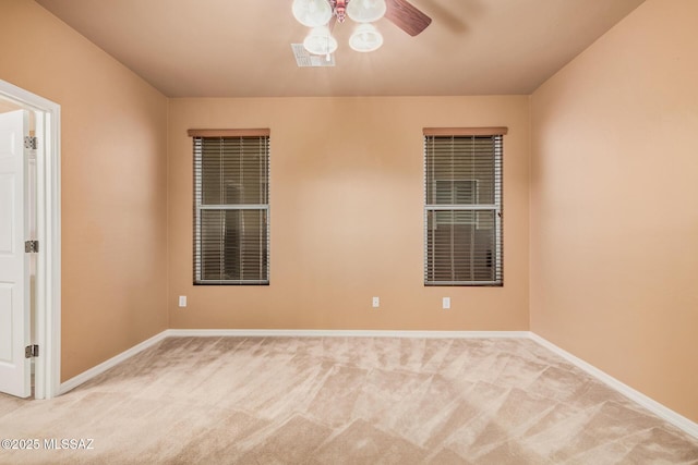 spare room with light carpet and ceiling fan