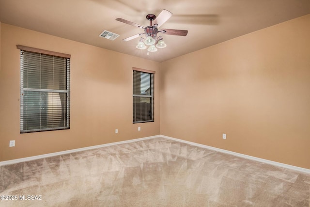 spare room featuring ceiling fan and carpet floors