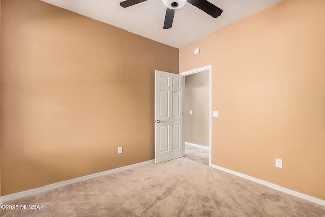 empty room featuring light colored carpet and ceiling fan