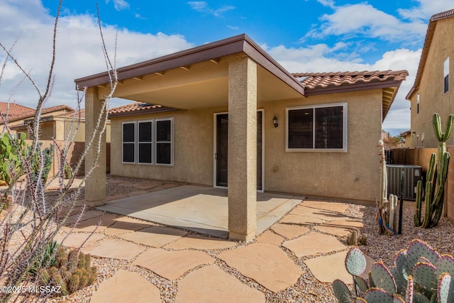 rear view of property featuring cooling unit and a patio