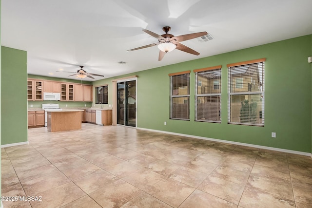 kitchen featuring light tile patterned flooring, a kitchen island, and ceiling fan