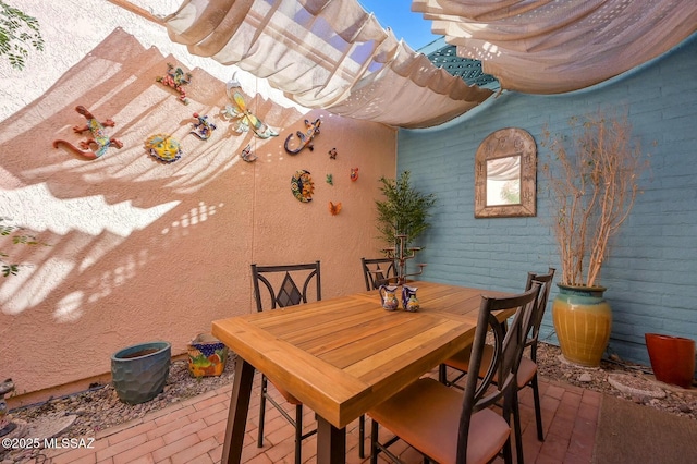 dining area featuring brick wall