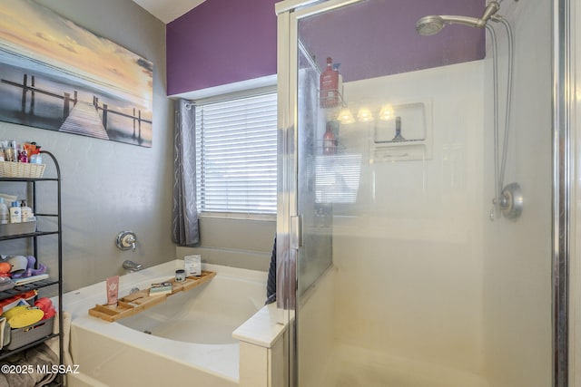 full bath featuring a garden tub and a shower stall