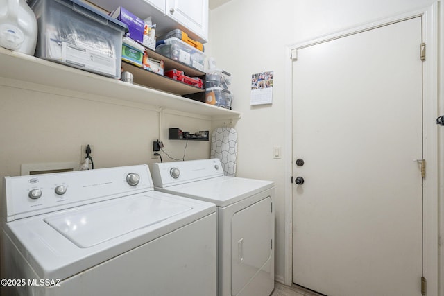 laundry room featuring cabinet space and washing machine and clothes dryer