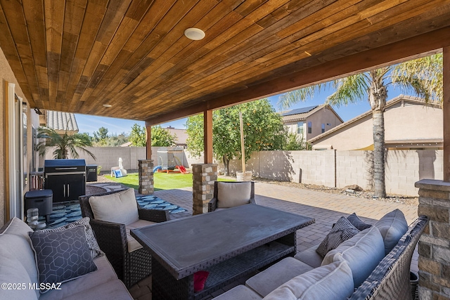 view of patio with a fenced backyard, outdoor lounge area, and a playground