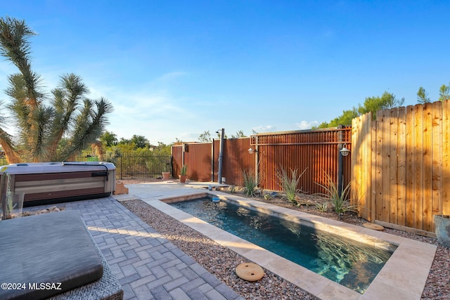 exterior space featuring a swimming pool with hot tub