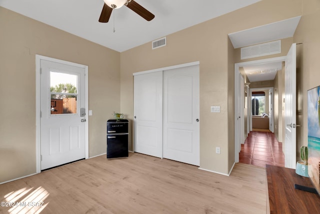 foyer entrance featuring ceiling fan and light hardwood / wood-style floors