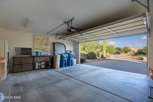 garage featuring a garage door opener and white fridge