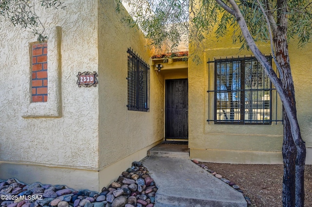 property entrance featuring stucco siding