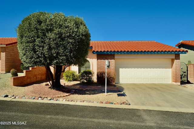 view of front of home with brick siding, driveway, a tiled roof, and an attached garage