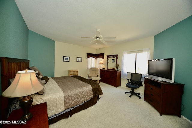 bedroom with ceiling fan, baseboards, and light colored carpet