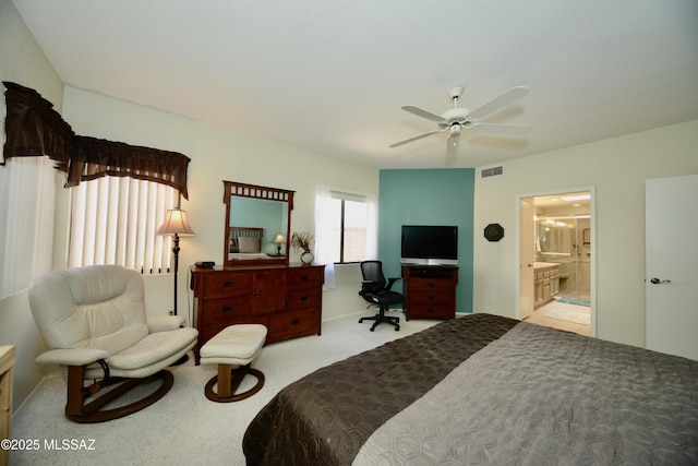 bedroom with connected bathroom, visible vents, ceiling fan, and light carpet