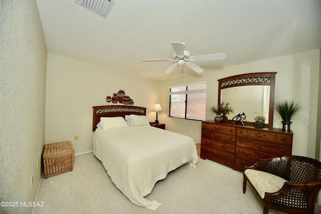 bedroom featuring ceiling fan, visible vents, and light colored carpet