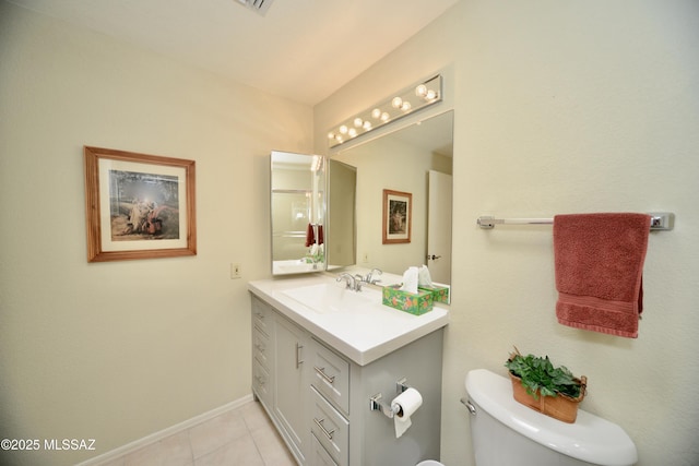 bathroom with tile patterned flooring, baseboards, vanity, and toilet