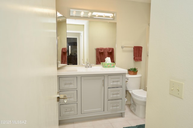 bathroom featuring toilet, tile patterned floors, and vanity