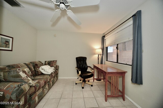 office with light tile patterned floors, ceiling fan, visible vents, and baseboards