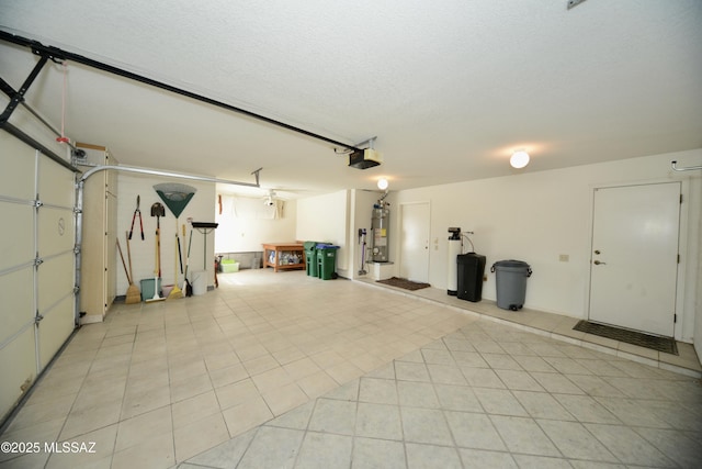 garage featuring gas water heater and a garage door opener