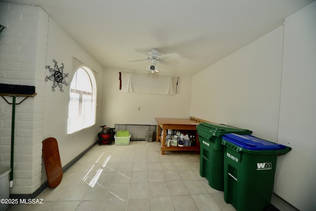 interior space with ceiling fan