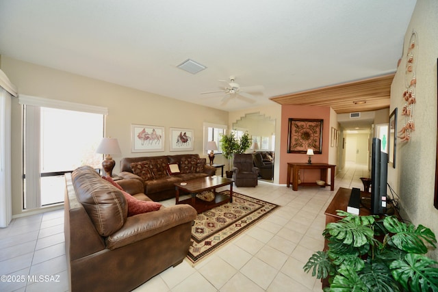 living room featuring light tile patterned floors, ceiling fan, and visible vents