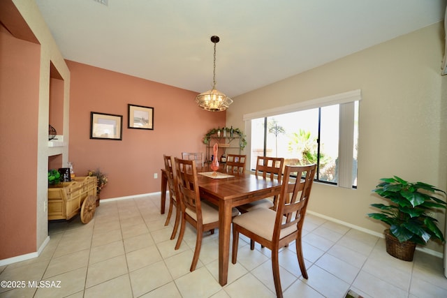 dining area featuring light tile patterned floors, baseboards, and a notable chandelier