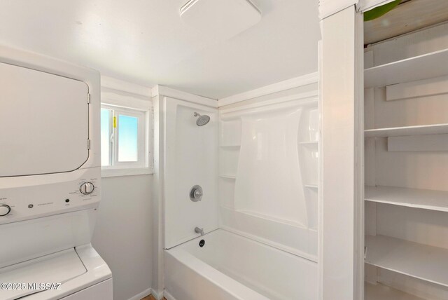 816 W 11th St, Safford, AZ 85546 - bathroom featuring stacked washer / drying machine, baseboards, and shower / washtub combination