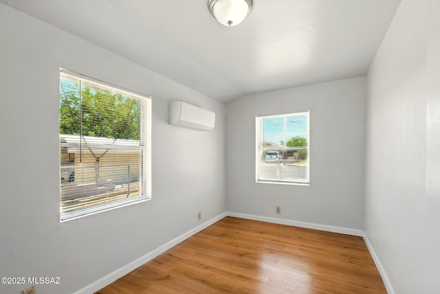 816 W 11th St, Safford, AZ 85546 - unfurnished room with a wall mounted AC, baseboards, and light wood-style flooring