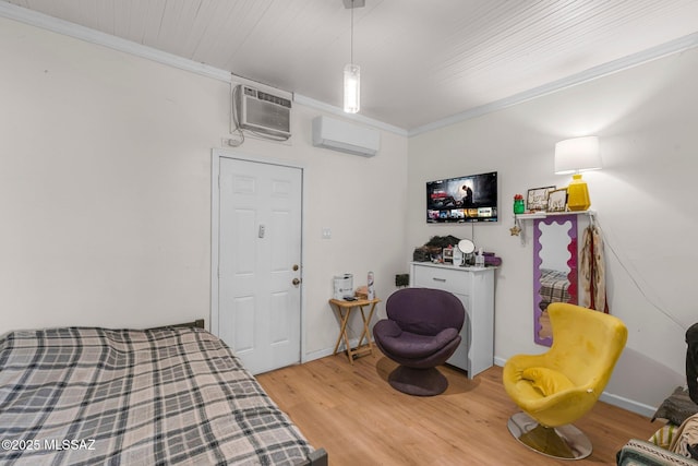 bedroom featuring ornamental molding, light hardwood / wood-style flooring, and an AC wall unit